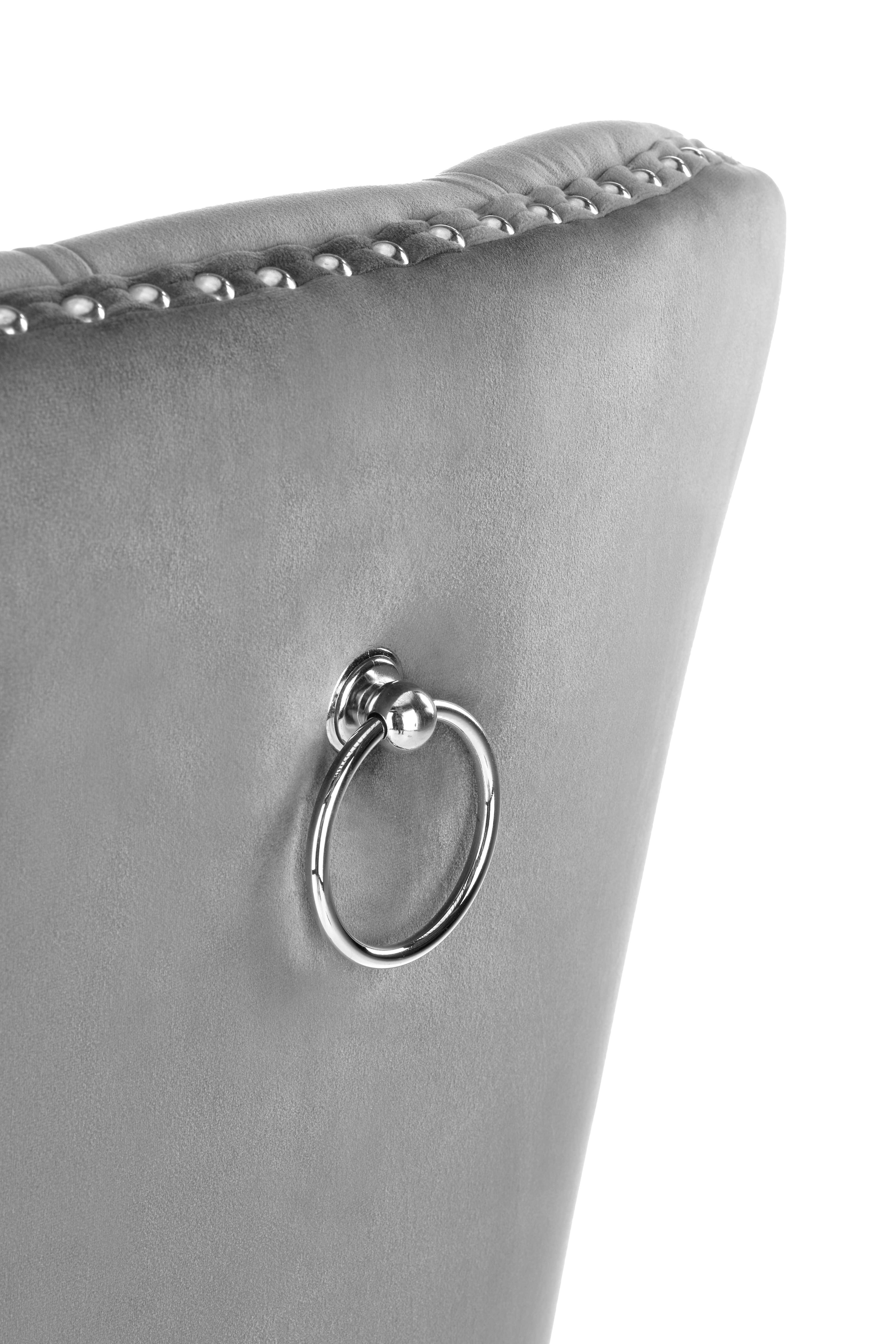 Zbliżenie na tył szarego krzesła MIYA z weluru z metalowym pierścieniem i ozdobnymi nitami.