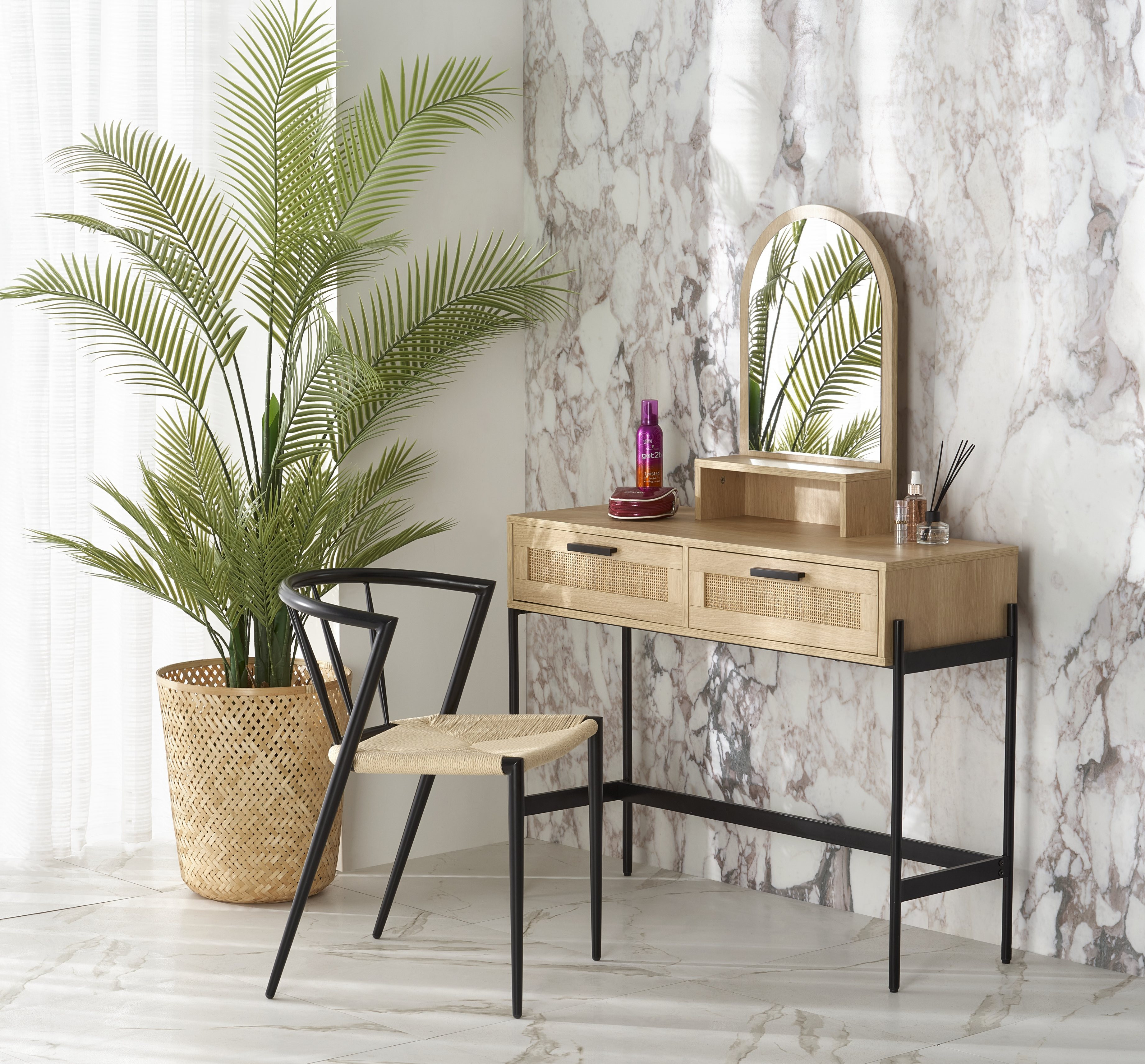 Konsolka CARMEN z naturalnego drewna i czarnymi nogami, z lustrem, dwoma szufladami, obok krzesło i roślina w donicy.