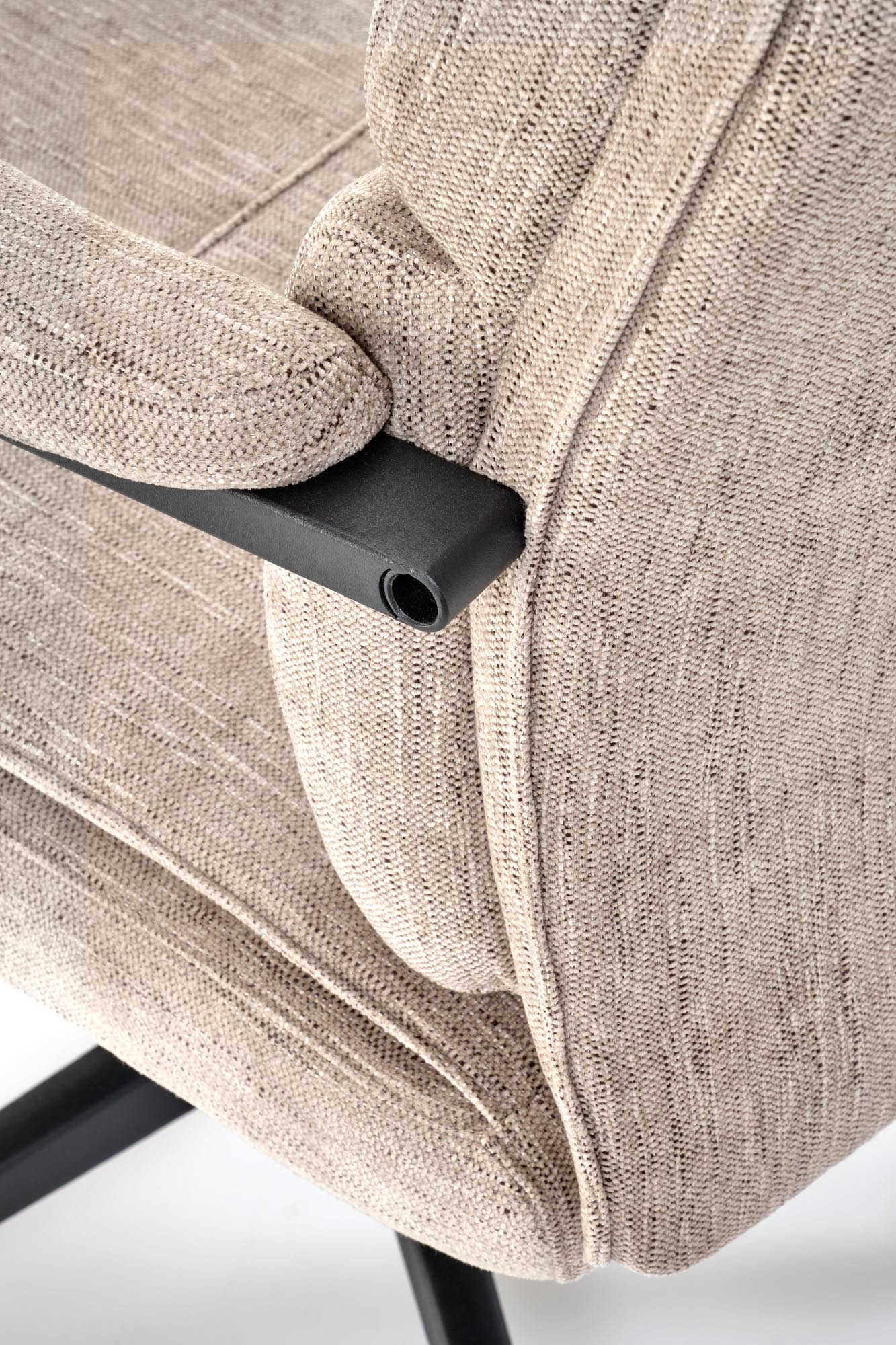 Zbliżenie na beżową tapicerkę i podłokietnik fotela obrotowego ADRIANO z ergonomicznym designem.