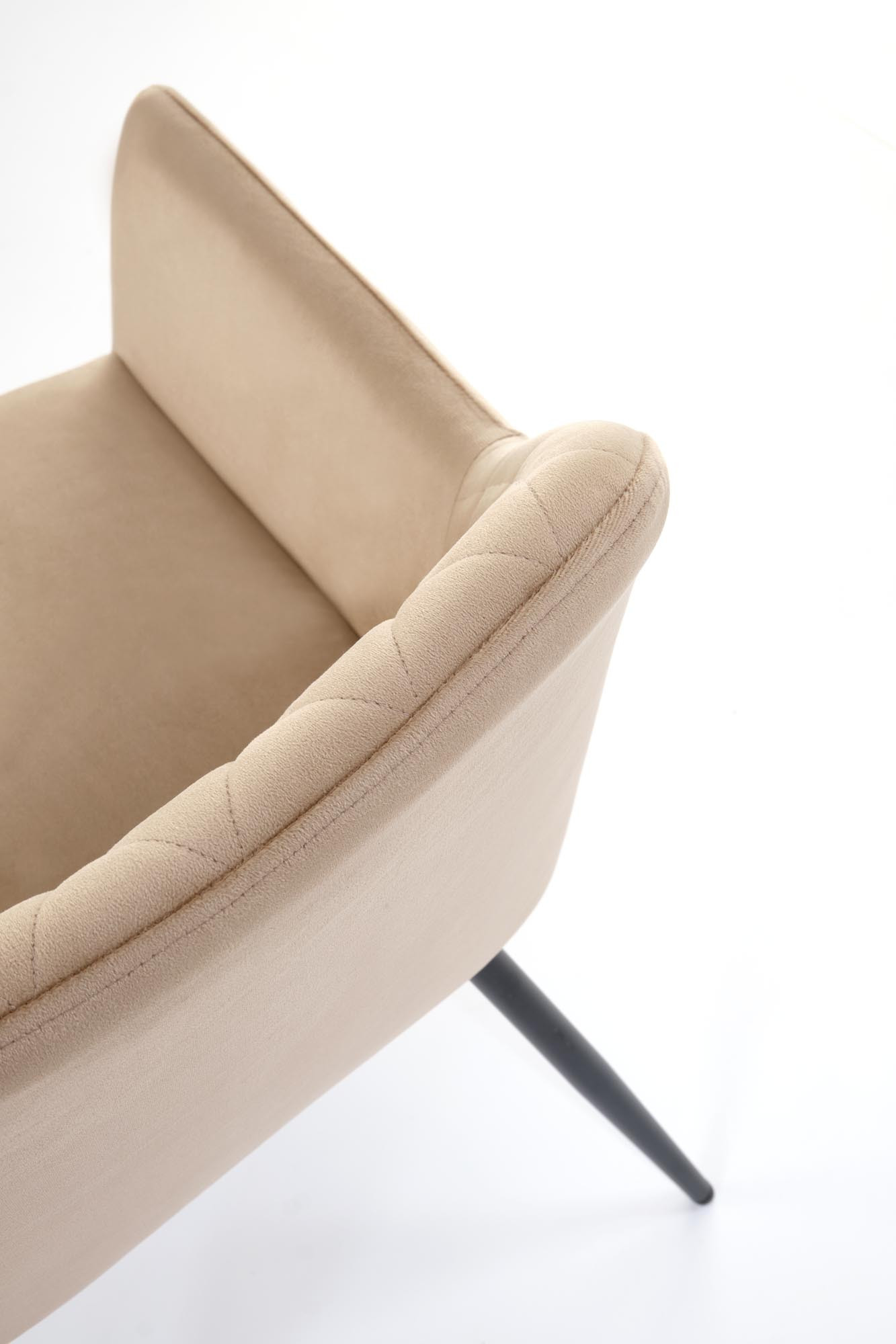 Zbliżenie na beżowe krzesło K558 z pikowanego aksamitu i stalowymi nogami.