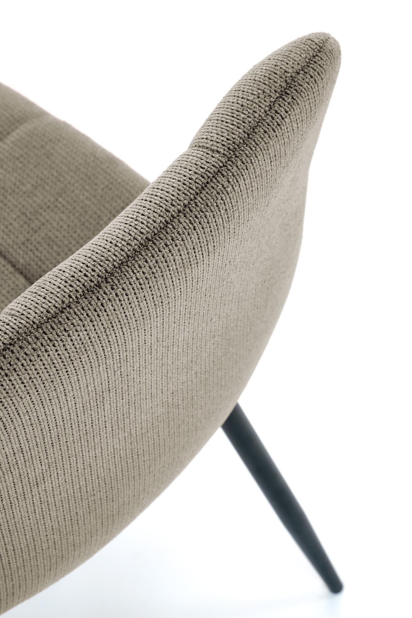 Zdjęcie detalu oliwkowego krzesła K560 z pikowanej tkaniny, stalowe nogi.